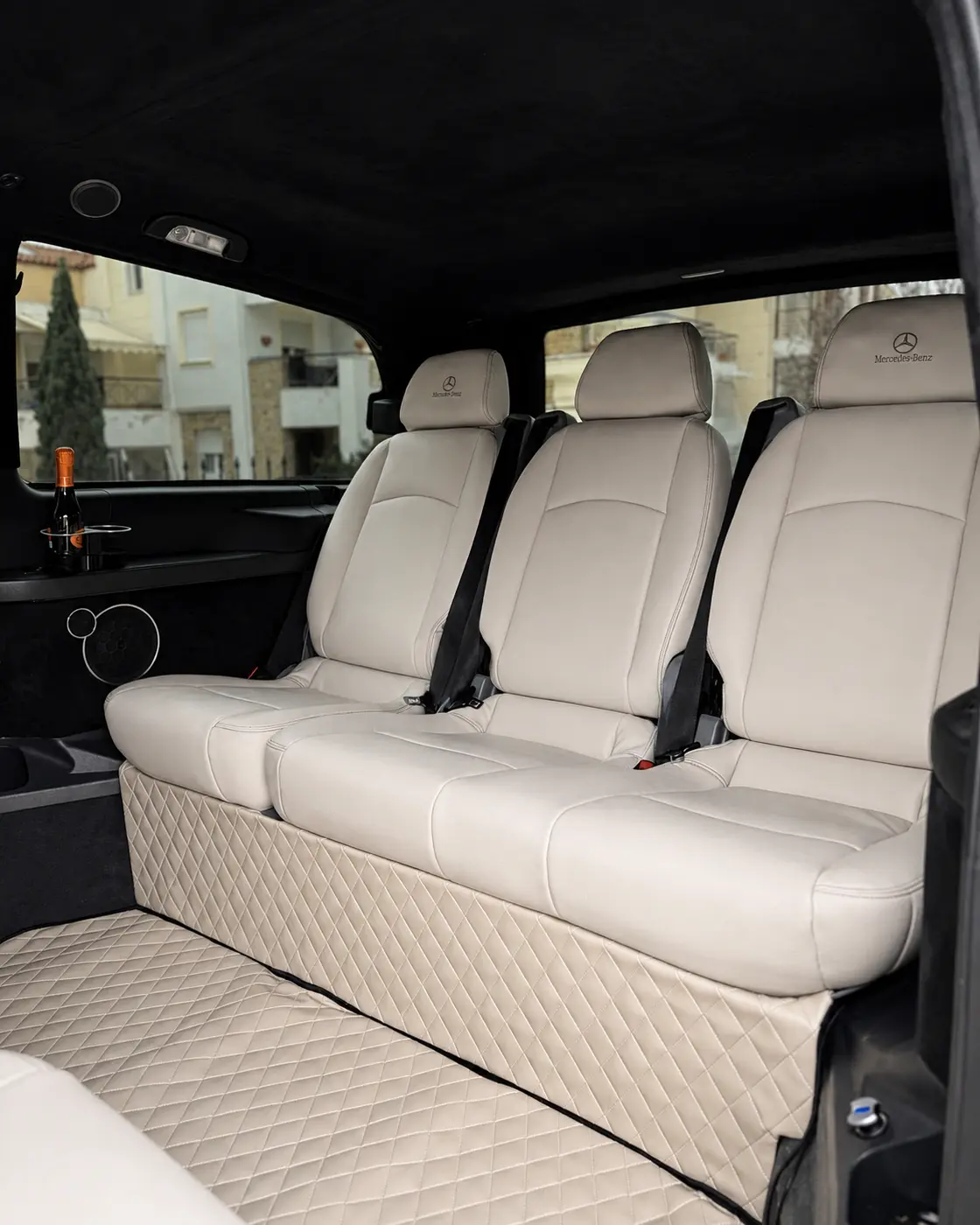 Three white leather passenger seats in the Argyriou VIP van